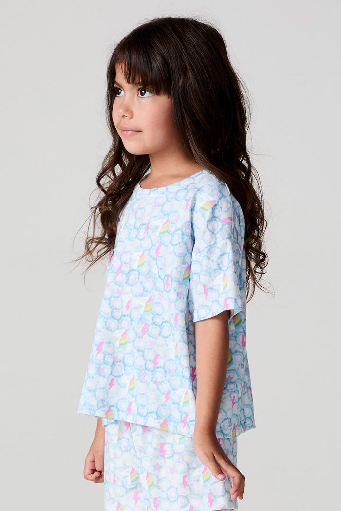 Side angle view of a girl wearing the Chaser Unicorn Lightning Tee on a neutral background