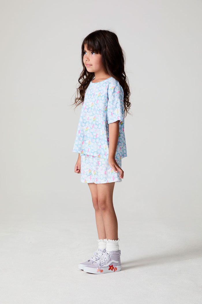 Full body view of a girl wearing the Chaser Unicorn Lightning Tee on a neutral backgroundront