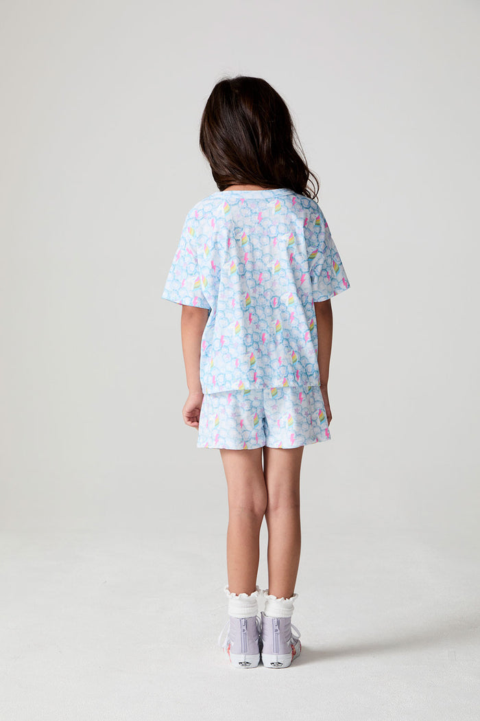 Full body back view of a girl wearing the Chaser Unicorn Lightning Tee on a neutral background