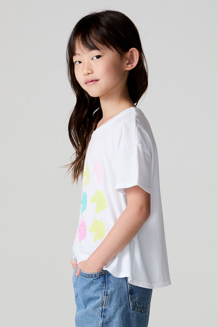 Side view of a girl wearing the Chaser Unicorn Parade Tee on a neutral background