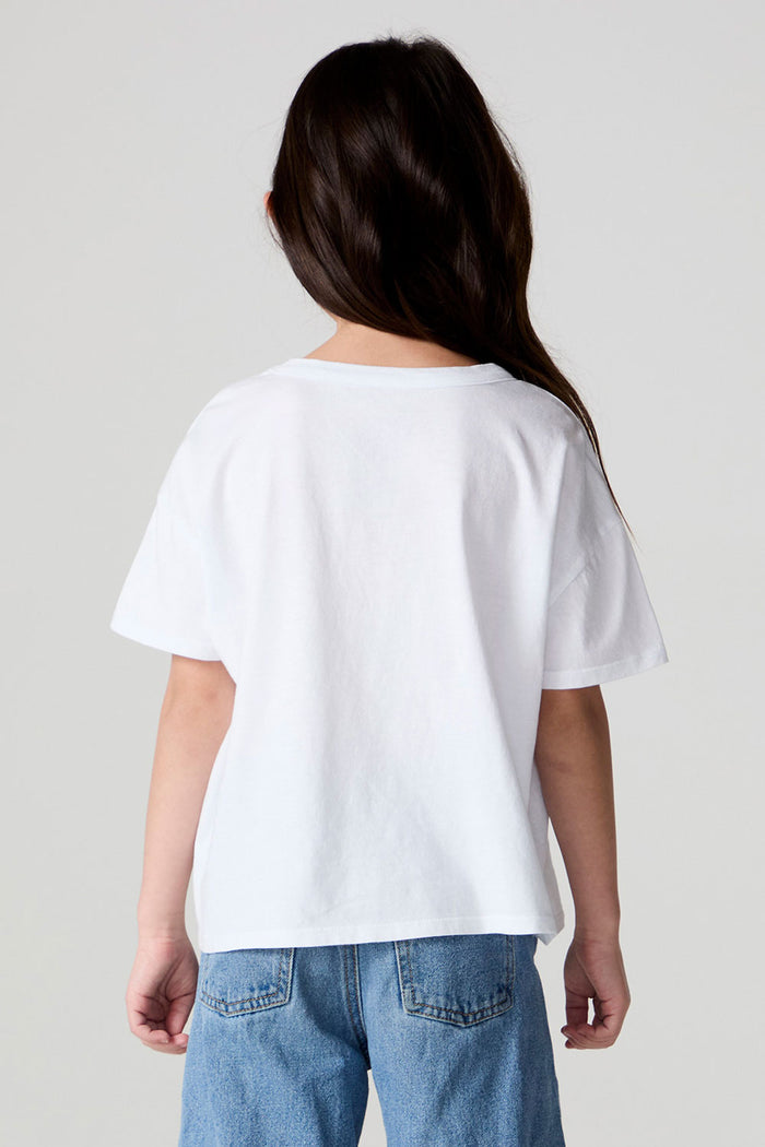 Back view of a girl wearing the Chaser Unicorn Parade Tee on a neutral background