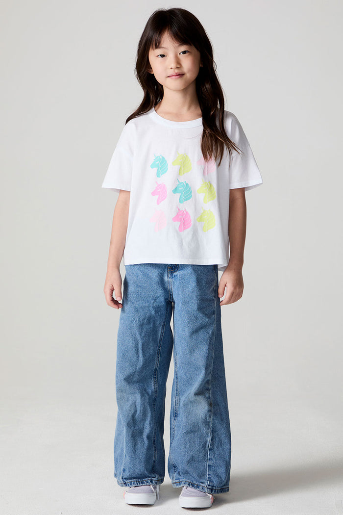 Full body front view of a girl wearing the Chaser Unicorn Parade Tee on a neutral background