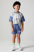 Full body front view of a boy wearing the Chaser U.S.A. Flag Shorts on a neutral background