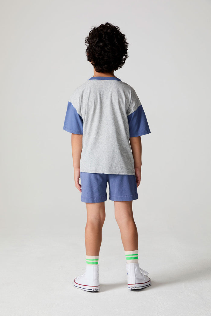 Full body back view of a boy wearing the Chaser U.S.A. Flag Shorts on a neutral background