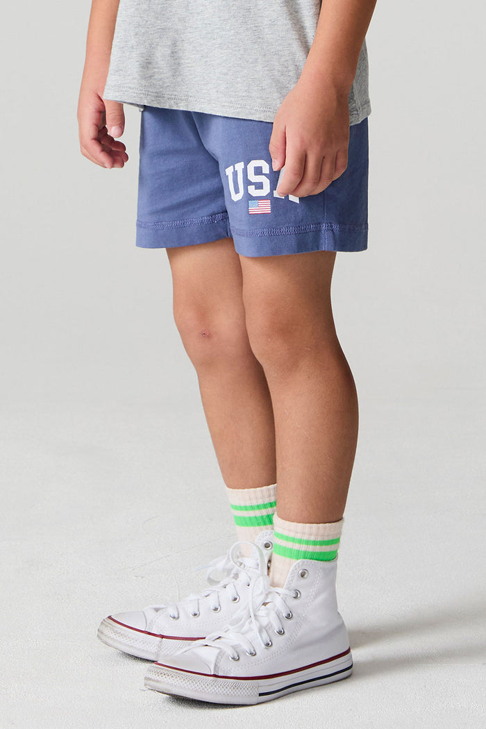 Side view of a boy wearing the Chaser U.S.A. Flag Shorts on a neutral background