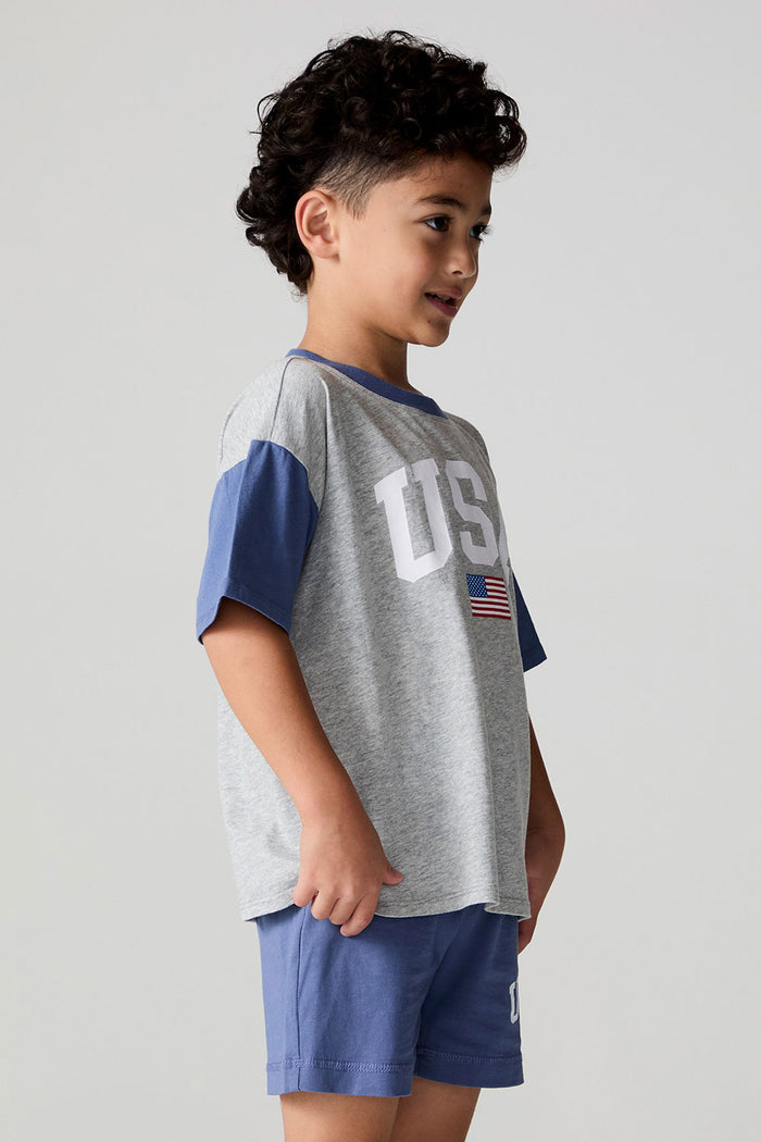 Side view of a boy wearing the Chaser U.S.A. Flag Tee on a neutral background