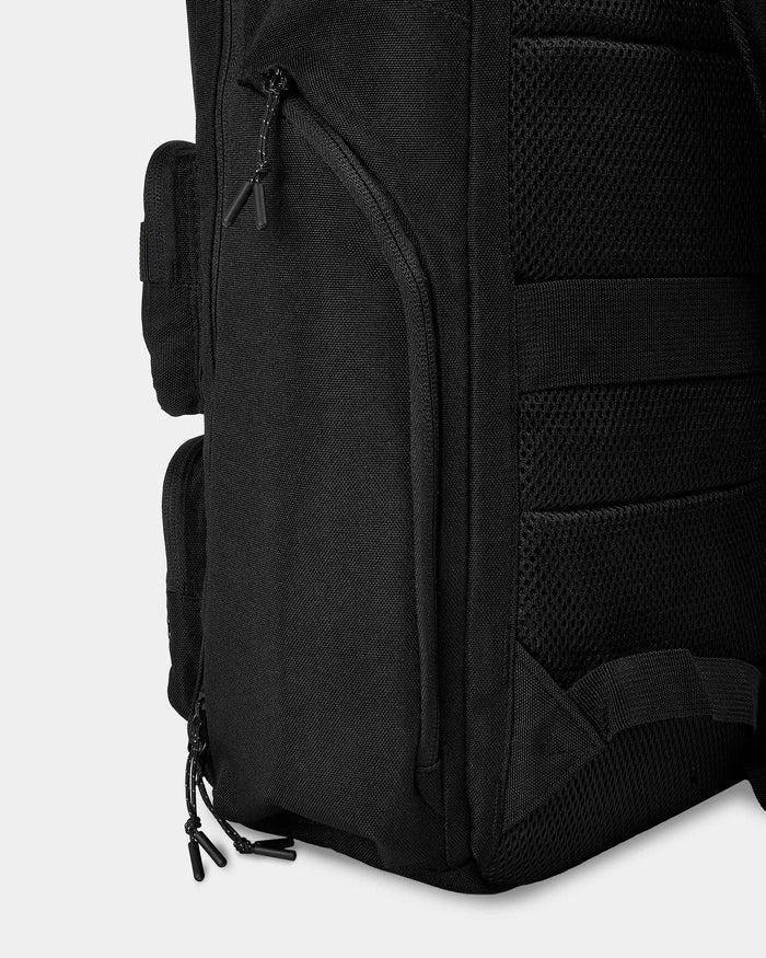 Black backpack with multiple compartments and straps on a white background