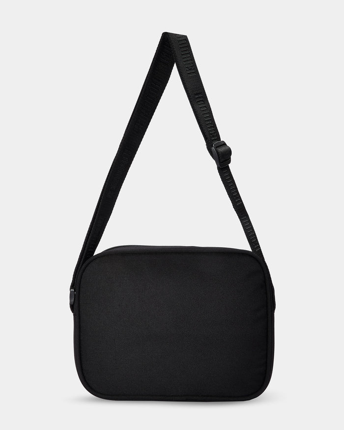 Black shoulder bag with a strap on a light gray background