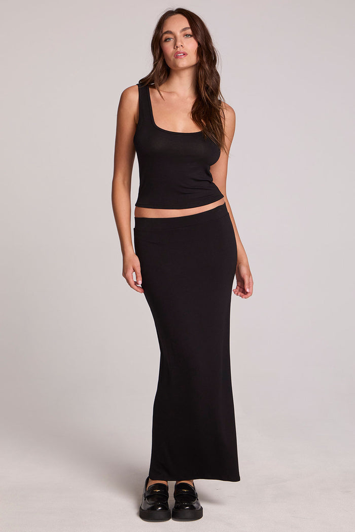 A full body front view of a woman wearing the Chaser Verze Black Top on a neutral background
