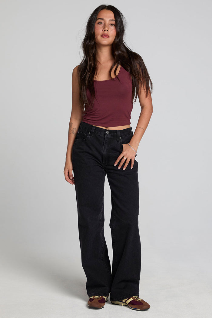 A full body front view of a woman wearing the Chaser Verze Brick Tank on a neutral background