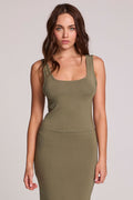 Front view of a woman wearing the Chaser Verze Forager Green on a neutral background with arms down