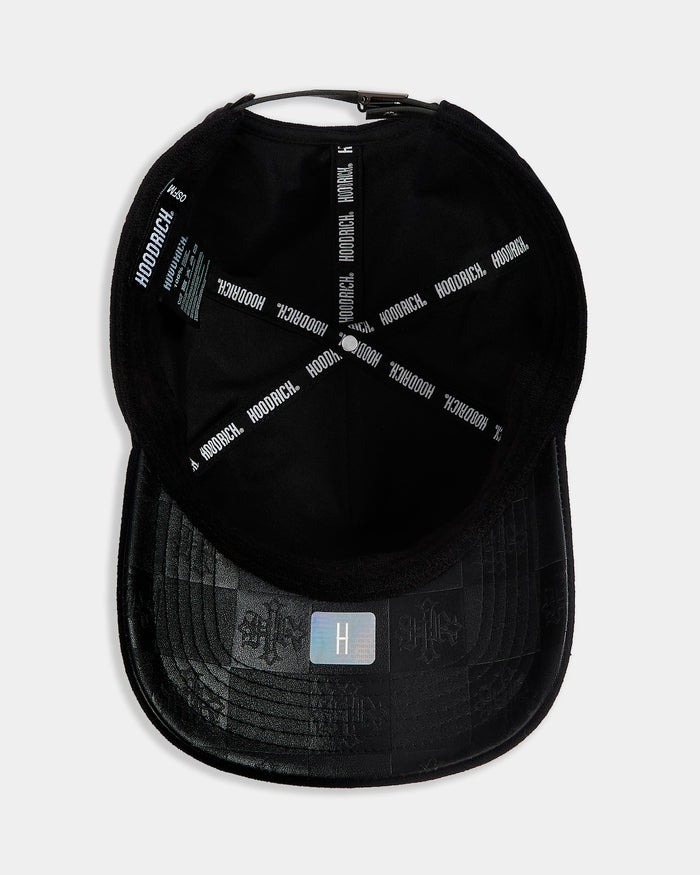 Black cap with branding on a light gray background