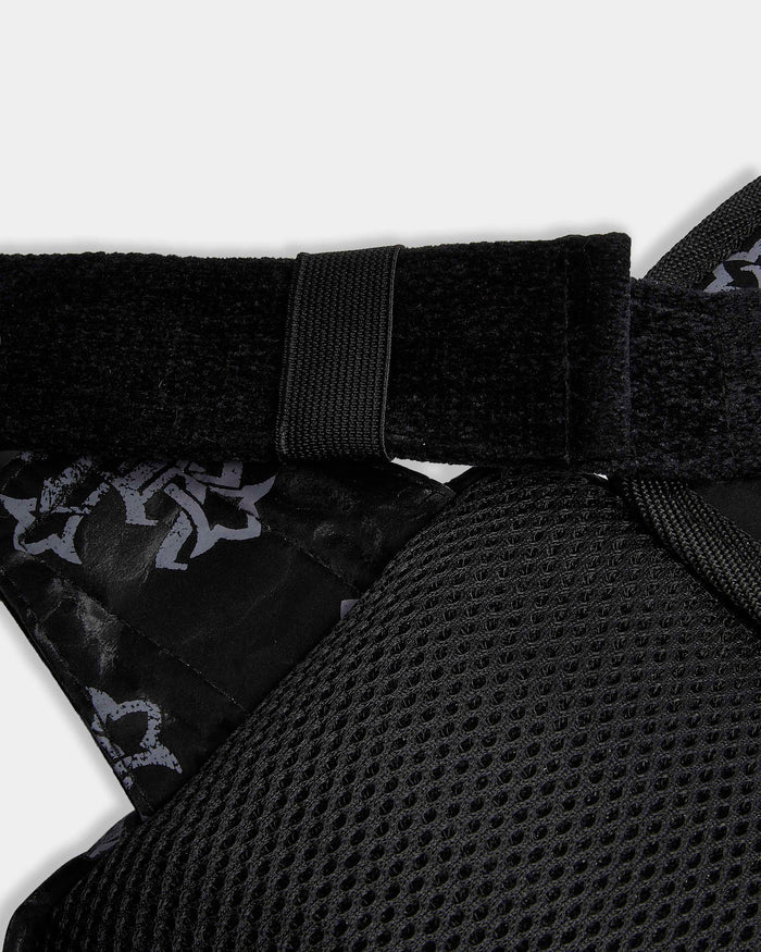 Close-up of a black protective pad with a strap on a white background