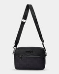 Black textured crossbody bag with a strap on a light gray background