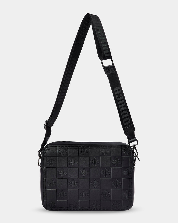 Black woven crossbody bag with a strap on a light gray background