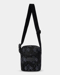 Black patterned crossbody bag on a light gray background
