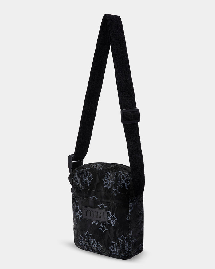 Black crossbody bag with subtle pattern on a white background