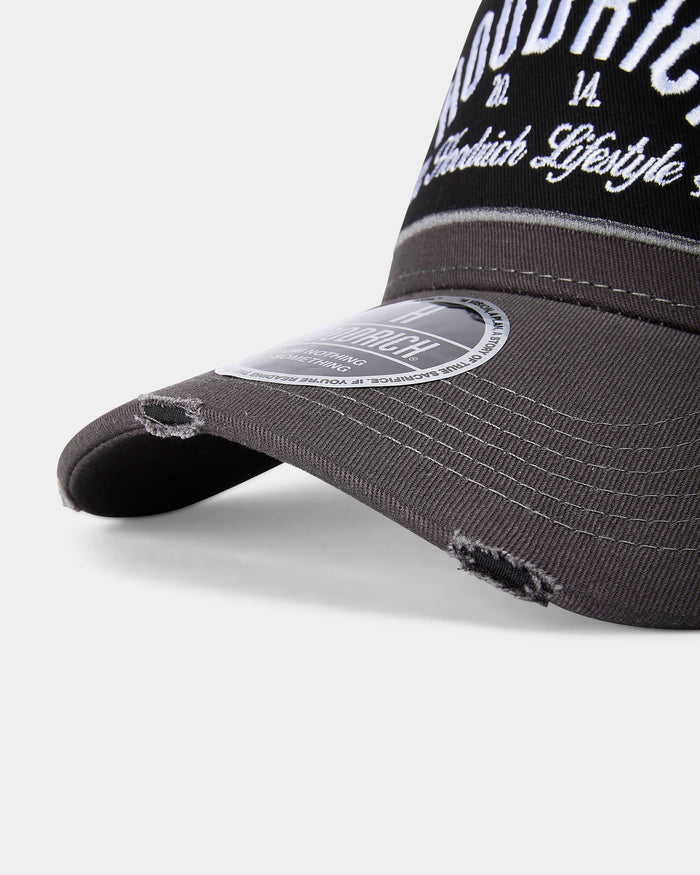 Black distressed baseball cap with white text on a light gray background