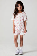 Full body front view of a girl wearing the Chaser Watermelon All Over Shorts  on a neutral background