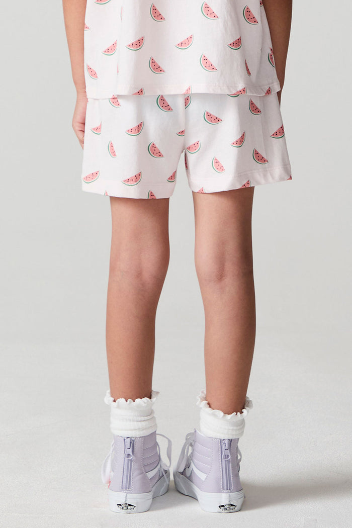 Back view of a girl wearing the Chaser Watermelon All Over Shorts  on a neutral background