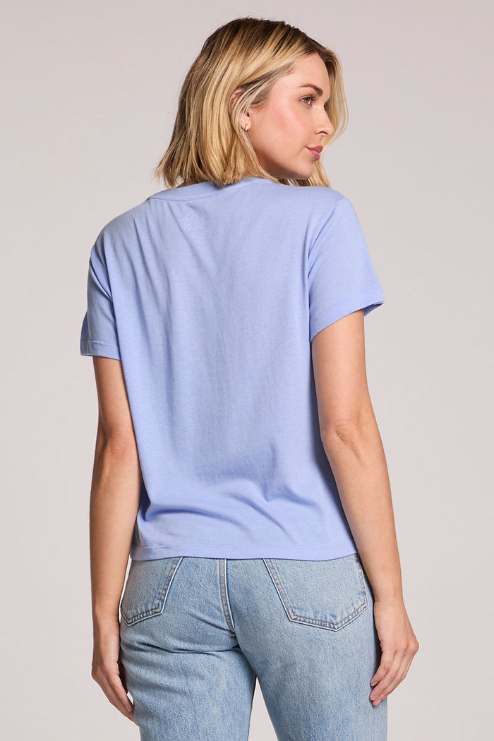 Back view of a woman wearing the Chaser  Weekend State Of Mind Tee on a neutral background