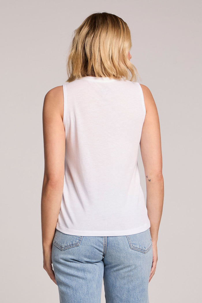 Back view of a woman wearing the Chaser  Wellness Relax Recharge Tank on a neutral background