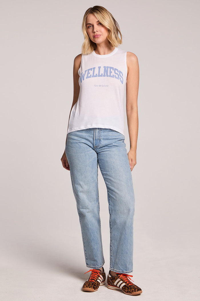 Full body front view of a woman wearing the Chaser  Wellness Relax Recharge Tank and sneakers on a neutral background