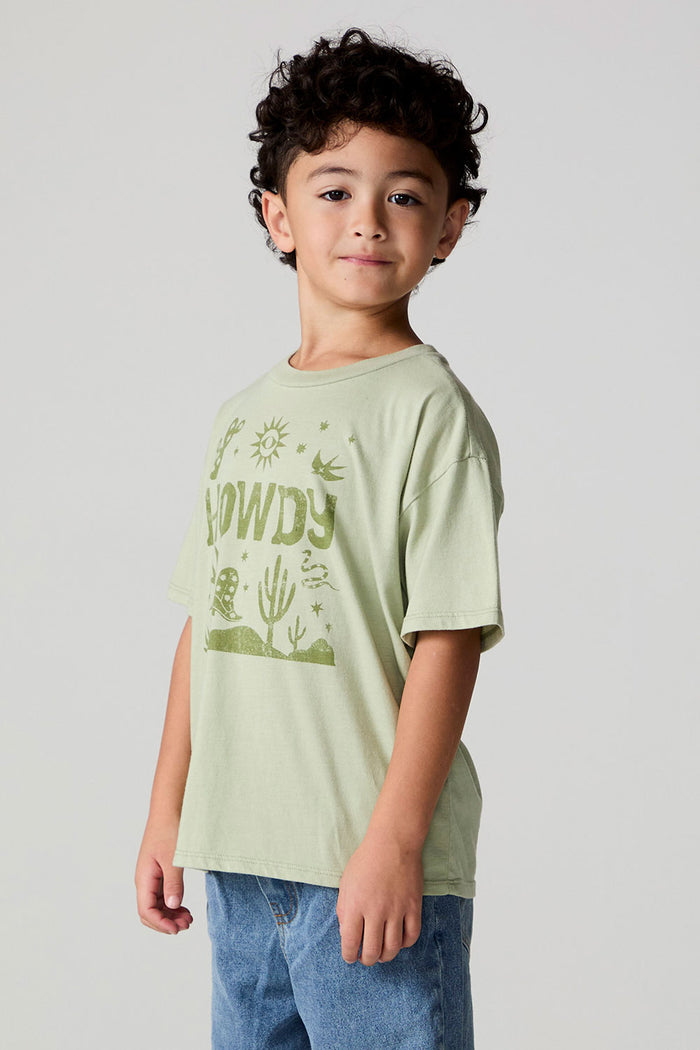 Side angle view of a boy wearing the Chaser Western Time Tee on a neutral background