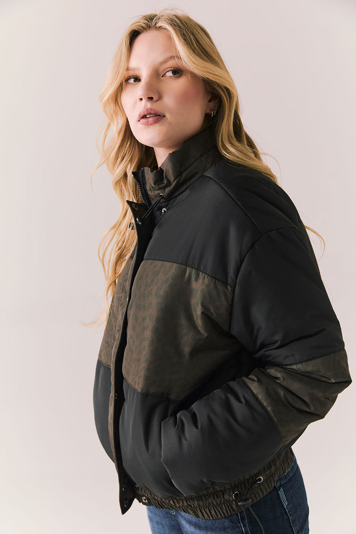 Side angle of Chaser Brand Whistler Leopard and True Black Puffer Jacket highlighting puffed silhouette and high collar