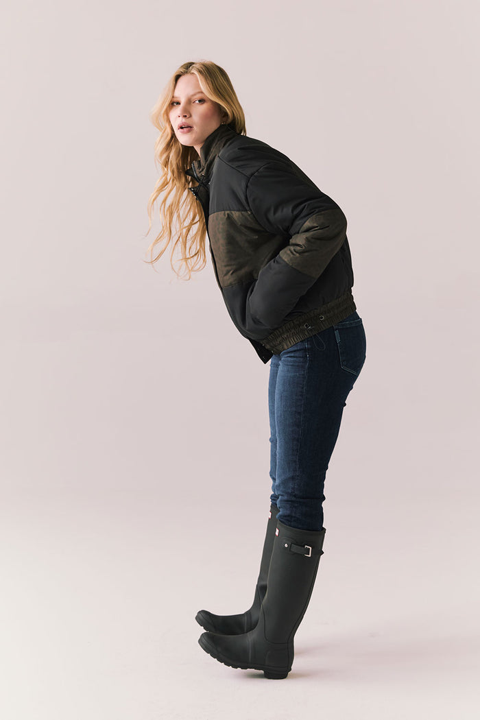 Full body angled pose of Chaser Brand Whistler Leopard and True Black Puffer Jacket styled with jeans and rain boots