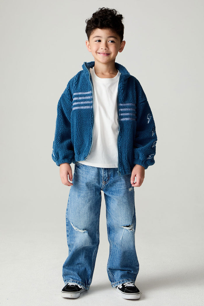 A full body front view of a boy wearing the Chaser White Bolts Boys Jacket on a neutral background