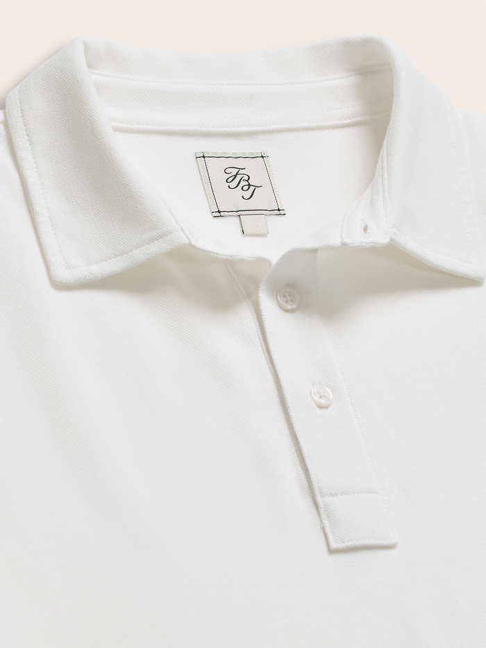 Close-up of white cotton pique polo shirt collar and brand label