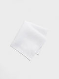 White linen pocket square folded on a light background