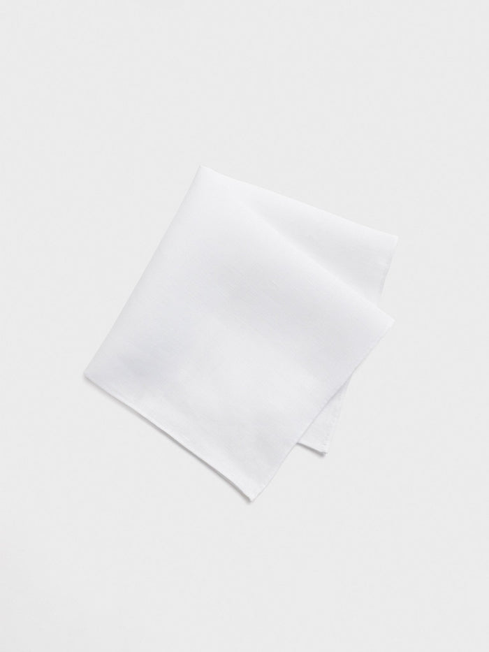 White linen pocket square folded on a light background