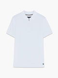 A man wearing a white cotton Polo shirt with short sleeves, a branded metal half zip and a regular fit.