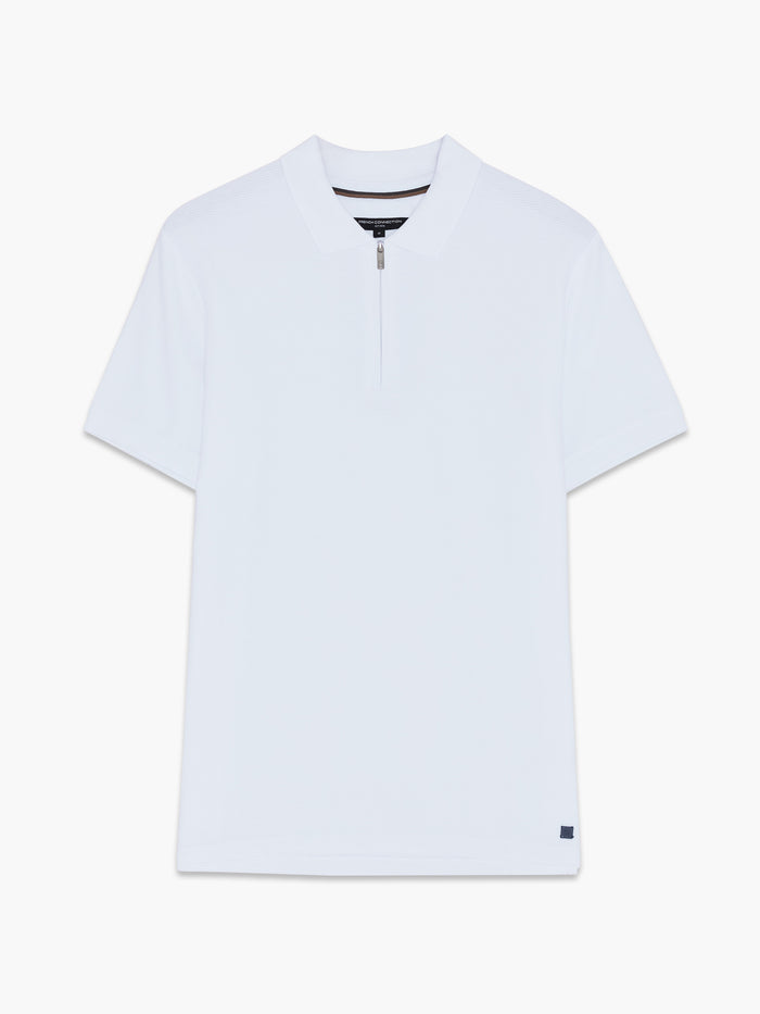 A man wearing a white cotton Polo shirt with short sleeves, a branded metal half zip and a regular fit.