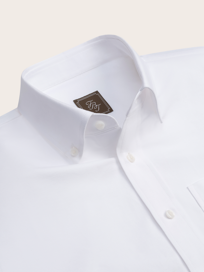 Close-up of white oxford shirt collar and button placket