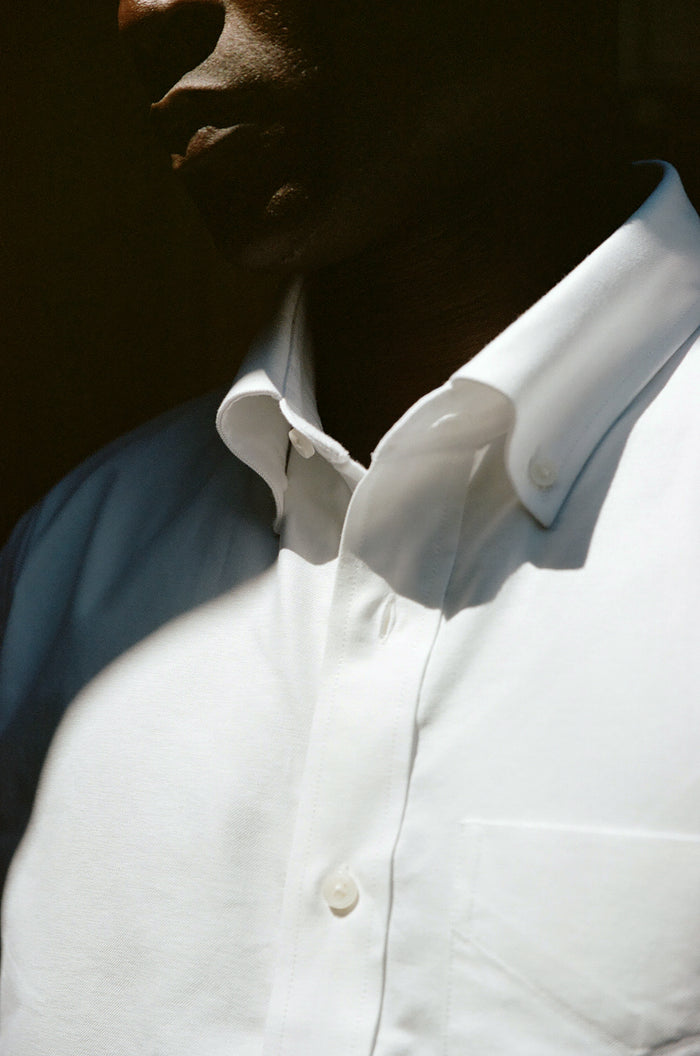 Close-up of man's white oxford shirt collar in sunlight