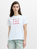 A woman wearing a regular fit white short sleeved T-shirt with a crew neckline and a noughts and crosses inspired graphic print.