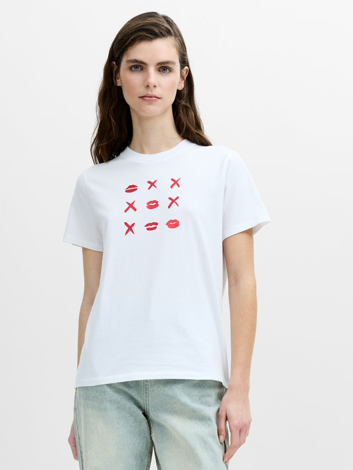 A woman wearing a regular fit white short sleeved T-shirt with a crew neckline and a noughts and crosses inspired graphic print.
