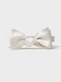 White satin butterfly bow tie, tied, front-facing on a light grey background.