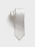 White silk necktie with textured twill, rolled on a plain background