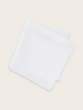 A white silk pocket square folded against a light background
