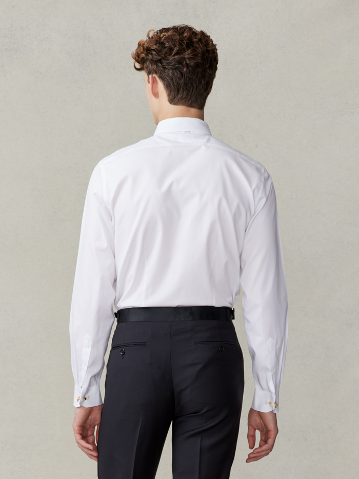 Back view of man in white stretch cotton dress shirt, waist-up