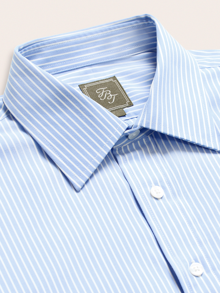 Close-up of light blue and white wide stripe dress shirt collar and brand label