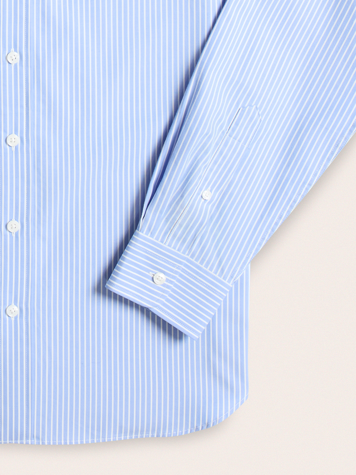 Close-up of light blue and white wide stripe dress shirt cuff and buttons