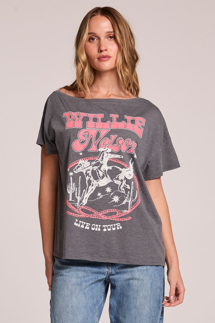 Front view of a woman wearing the Chaser  Willie Nelson 77 Tour Tee and jeans on a neutral background