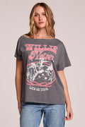 Front view of a woman wearing the Chaser  Willie Nelson 77 Tour Tee and jeans on a neutral background