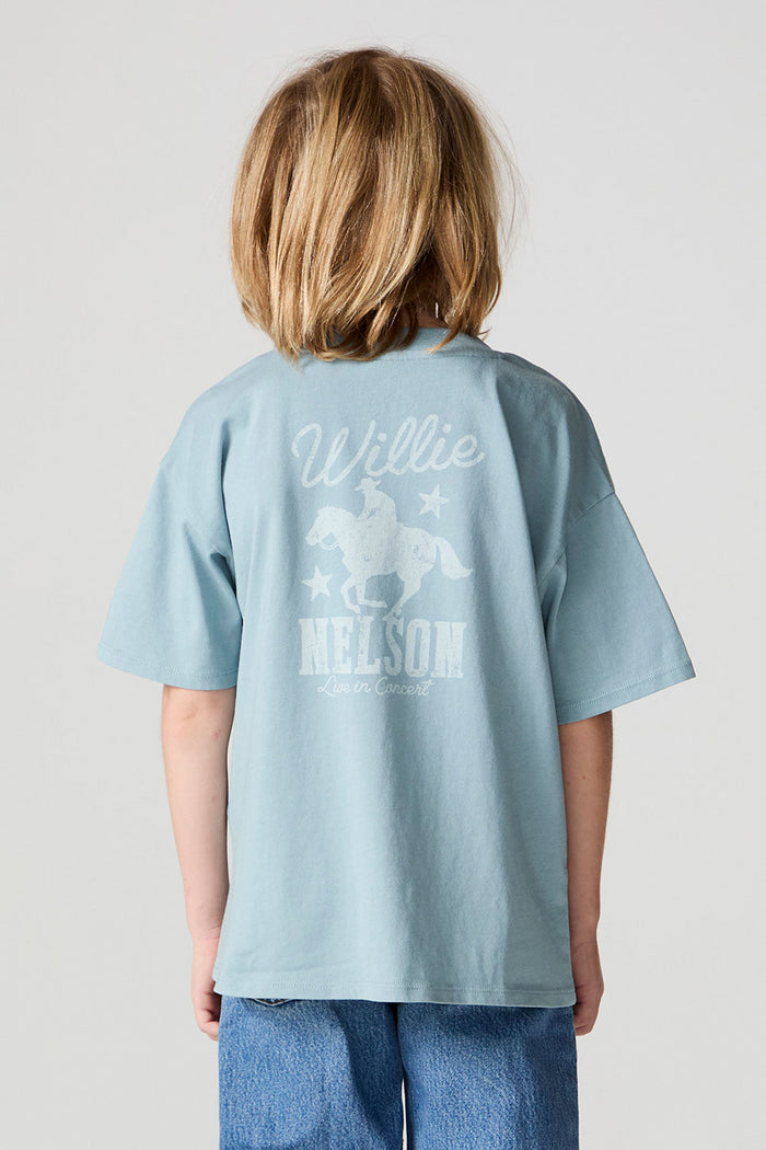 Back view of a boy wearing the Chaser Willie Nelson Rider Tee on a neutral background