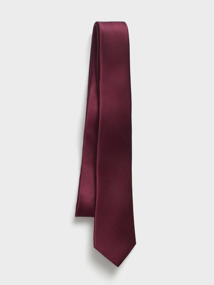 Wine silk necktie draped straight with folded loop at top, light grey background
